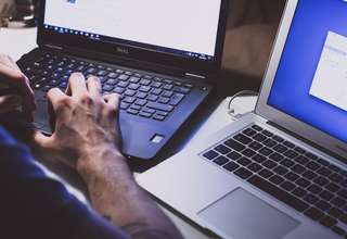 Concerned person using laptop with privacy warning symbols representing free VPN security risks