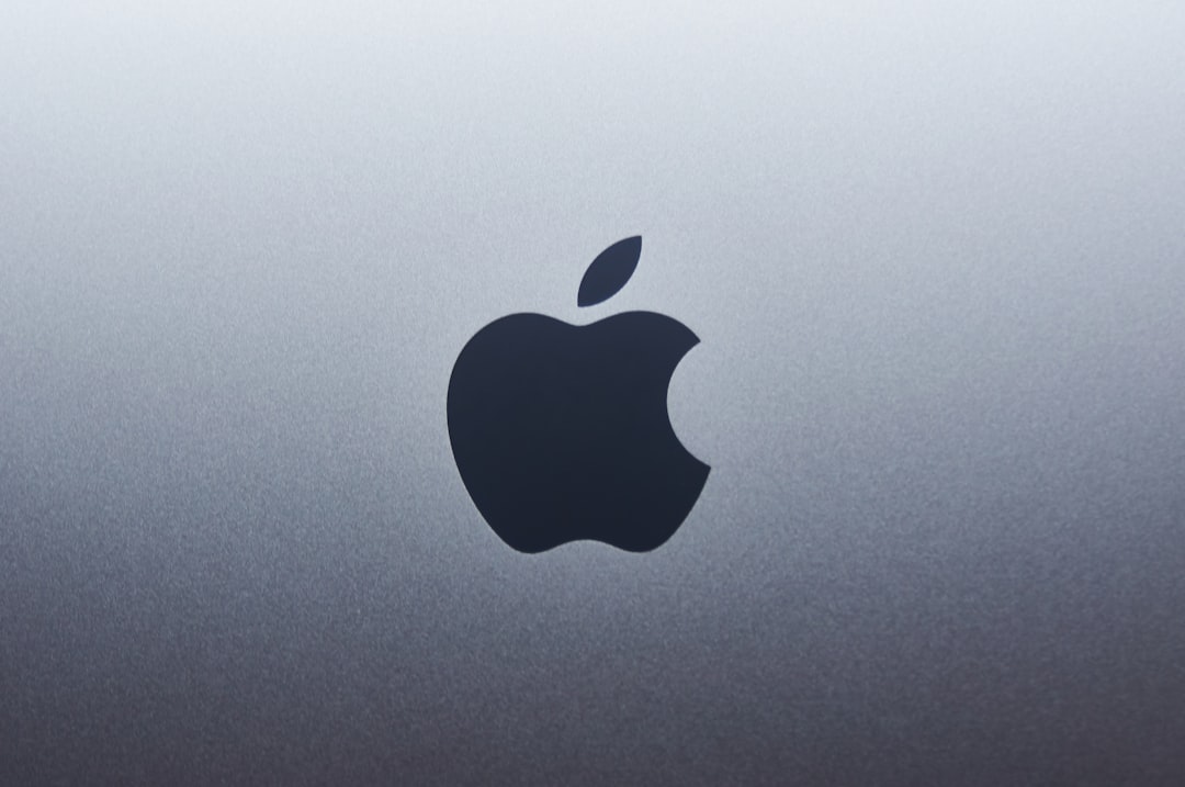 MacBook and iPhone displaying VPN security protection shield icon on screen