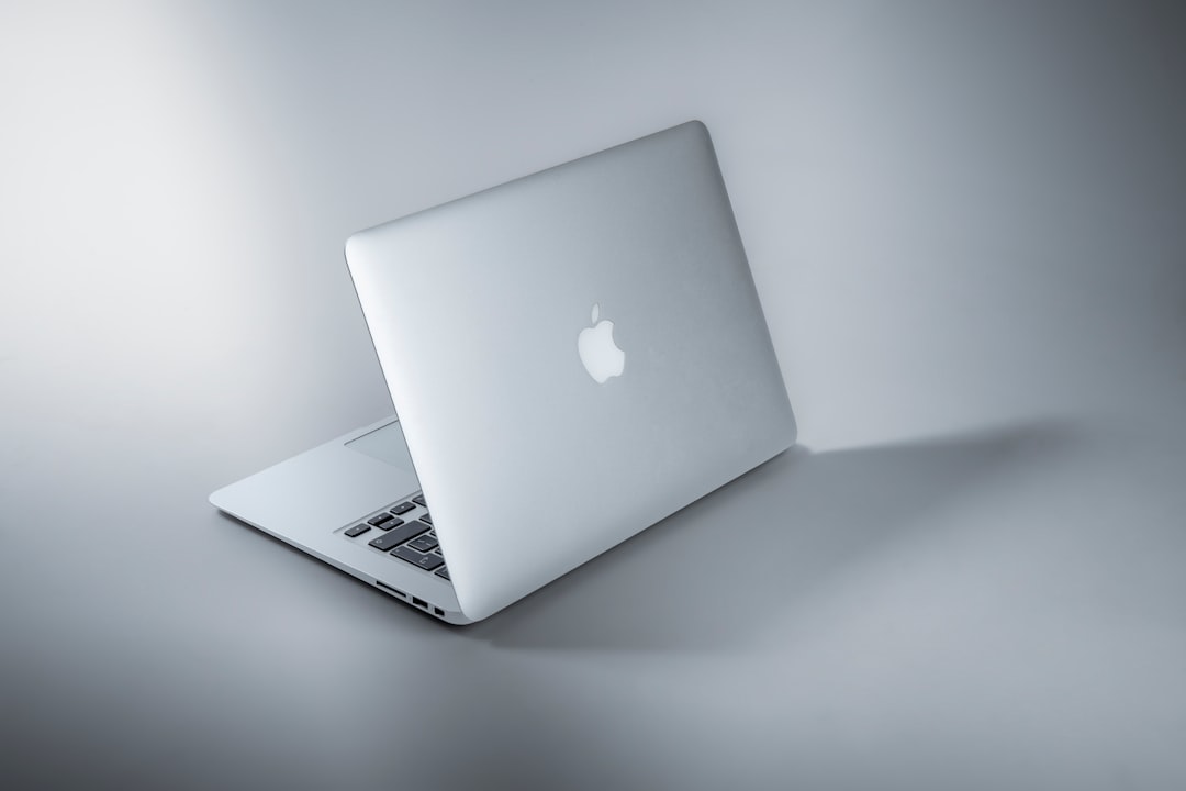 Person setting up VPN on MacBook laptop for secure browsing and privacy protection