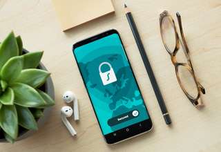 Person using iPhone with VPN protection for secure browsing and privacy