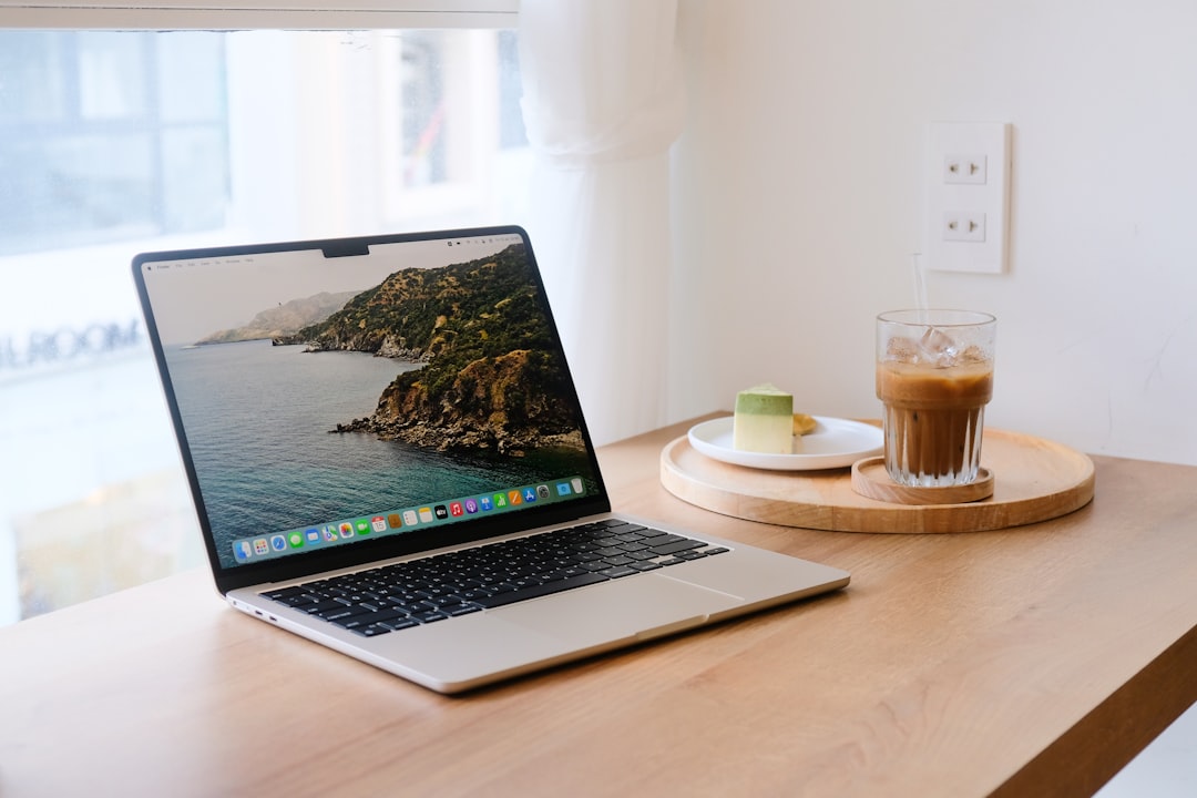 MacBook user connecting to public Wi-Fi network in coffee shop with VPN protection