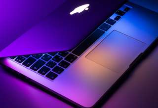 MacBook user reviewing online privacy settings and security features on macOS