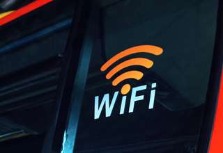 iPhone user connecting to public Wi-Fi network in coffee shop showing security risks