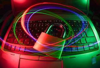 Person choosing between VPN and proxy server on laptop with security icons